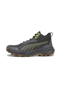 Scarpe da escursionismo grigie con accenti verde lime, dotate di una parte superiore testurizzata, punta rinforzata e suola in gomma con tasselli per la trazione.