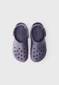 Purple molded clogs made of lightweight material. Features perforated holes for ventilation, back strap, and textured insole for grip.