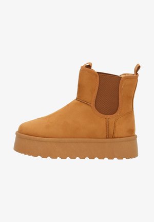 Stivaletto in suede beige con pannelli elasticizzati laterali e linguetta di pull. Caratterizzato da una suola in gomma spessa e strutturata. Design minimalista, finitura liscia.