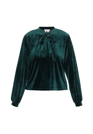 Žalios aksominės ilgos rankovės viršus su aukštu kaklu ir raištelių detale priekyje. Turi surinktus rankogalius ir laisvą siluetą. Sklandus paviršius.