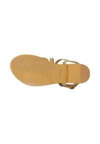 Flat tan sandal sole with textured grip and light brown straps visible from the side on a white background.