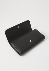 Black leather wallet with a textured finish, featuring a single gold snap closure and an open design showcasing the interior.