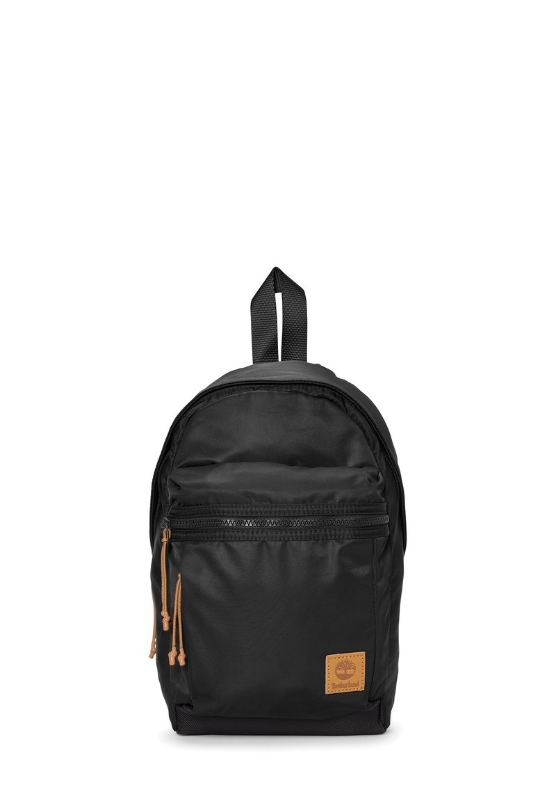 Zaino nero realizzato in nylon, dalla forma arrotondata, con una tasca frontale con zip, dettagli beige e una maniglia superiore per il trasporto.