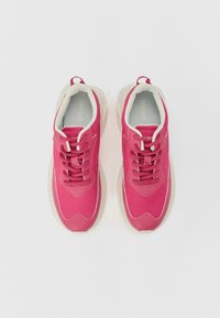 Pink athletic shoes with a mesh upper, textured laces, and a cushioned, cream-colored sole. Interior features light blue padding.