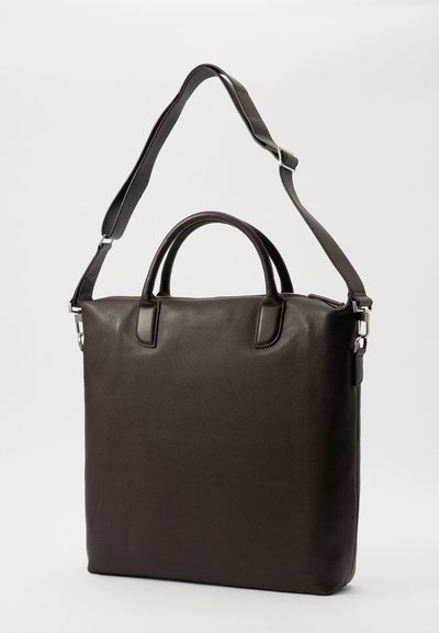 Black leather laptop bag with dual handles, removable shoulder strap, and a smooth texture. Features minimalistic design and silver hardware accents.