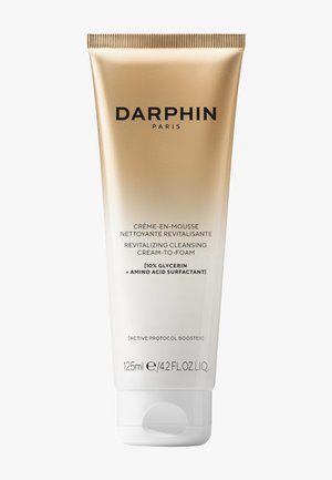 Crème nettoyante revitalisante Darphin Paris transformable en mousse avec 10 % de glycérine et tensioactif aux acides aminés dans un tube de 125 ml doré et blanc.