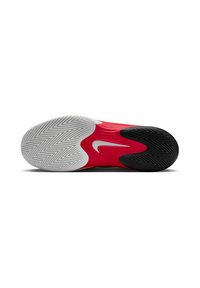 Sole di scarpa atletica rossa e nera con motivo a spina di pesce, logo Nike bianco e gomma texturizzata per trazione e presa.