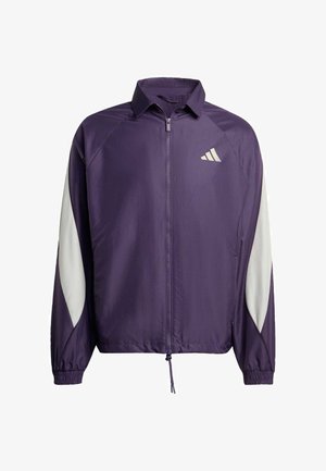 Paarse jas met witte accenten, rits aan de voorkant, kraag, elastische manchetten en een trekkoord onderaan. Bevat logo op de borst. Lichte, gladde stof.