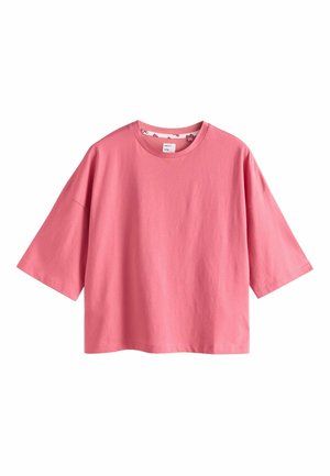 Short pink cotton t-shirt with a round neckline and short, wide sleeves. Smooth texture, relaxed fit, and no visible patterns or graphics.