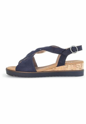 Navy blue suede wedge sandal with a cork platform, featuring crisscross straps and an adjustable ankle buckle. Textured outsole for grip.