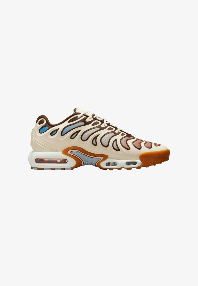 Sneaker featuring a cream upper with brown and light blue accents, wavy design, transparent air cushion sole, and textured midsole.