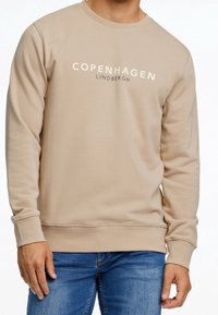 Felpa beige con scollo tondo, polsini e orlo a coste. Presenta le scritte "COPENHAGEN" e "LINDBERGH" in colore a contrasto. Tessuto dalla texture morbida.