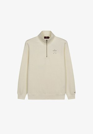 Pull en demi-zippé crème, fabriqué en tissu doux. Présente un petit motif brodé sur la poitrine ainsi que des poignets et un ourlet côtelés.