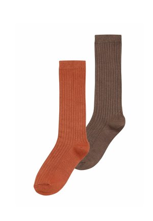 One orange and one brown ribbed mid-calf sock laid flat on a white background.
