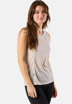 Light beige athletic tank top with a smooth texture, rounded neckline, and subtle side seams. Features a small blue logo at the hem.