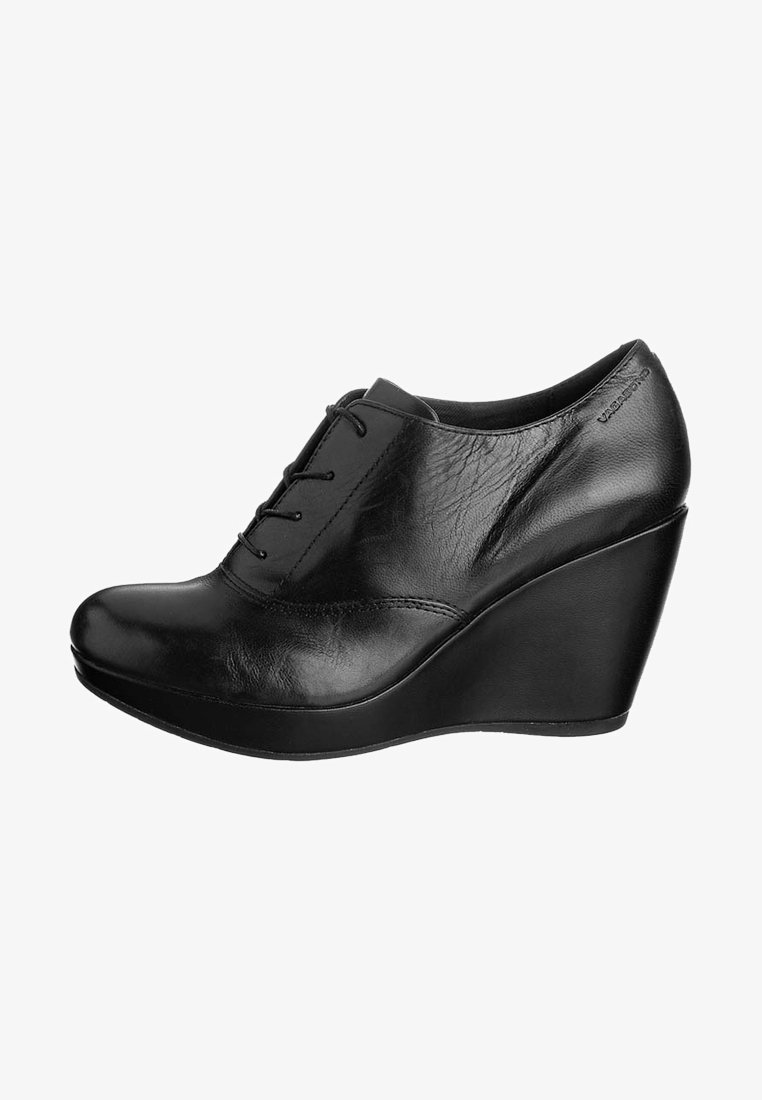 Black leather wedge shoes with a smooth texture, rounded toe, lace-up design, and a high wedge heel, featuring subtle stitching details.