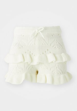 Hvite strikkede shorts med et teksturert mønster og volangkant. Designet med en bred elastisk midjebånd og snor for justerbar passform.