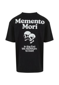Svart bomull t-skjorte med hvit tekst: "Memento Mori" og to hodeskaller, med "I slutten vender vi alle tilbake til støv" under. Korte ermer, vanlig passform.