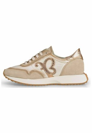 Beige sneaker with glossy and suede materials, features a decorative golden butterfly logo, round toe, and a textured rubber sole.