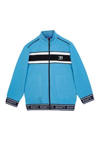 Giacca blu con zip e colletto alto, caratterizzata da strisce orizzontali bianche e nere e due tasche frontali. Include una vita nera con logo.