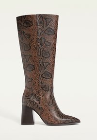 Brown faux snake skin knee-high boot with a pointed toe and chunky heel. Features a textured pattern and smooth finish on the shaft.