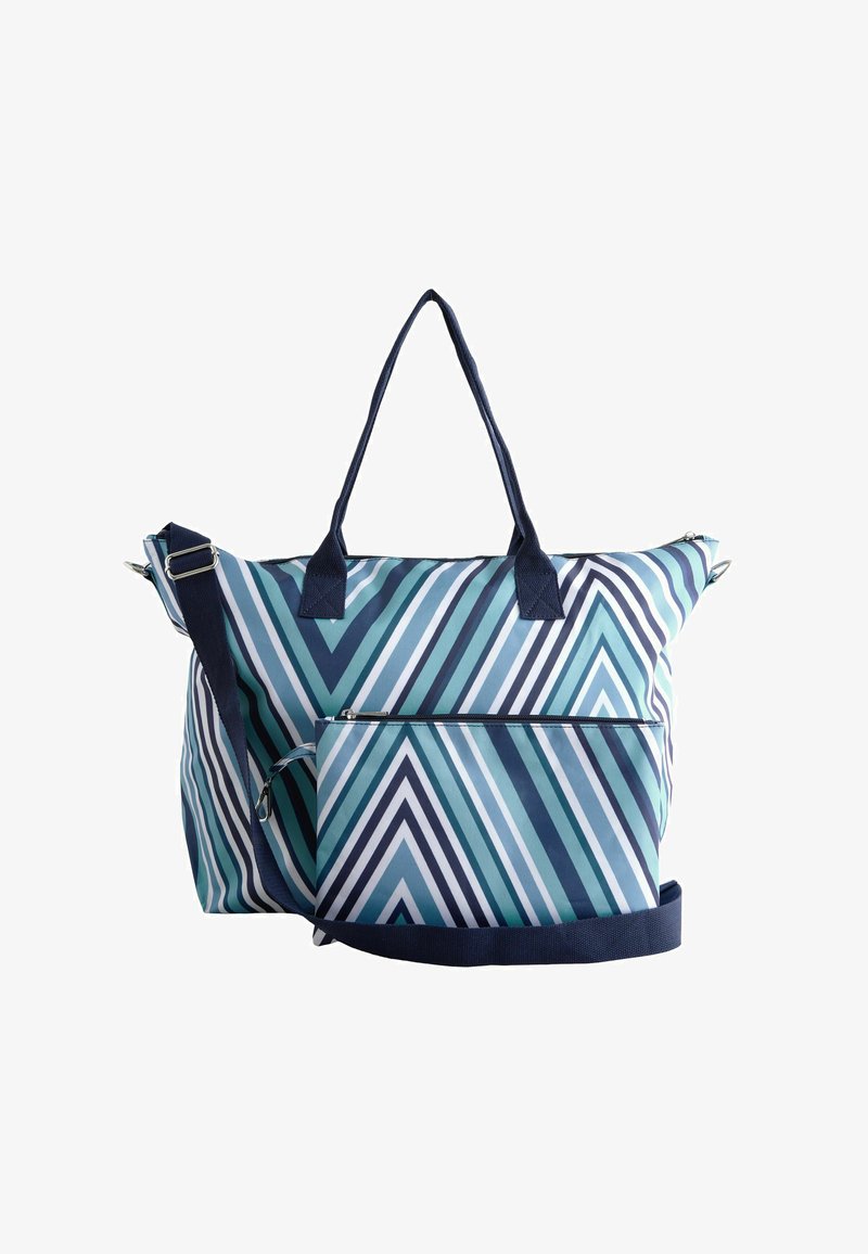 Velika torba za nošenje z geometrijskim chevron vzorcem v teal, modri in beli barvi. Vključuje dve ročki in snemljiv naramni trak.
