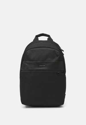 Black backpack made of durable fabric, featuring a smooth front panel, zippered compartments, and a padded handle for easy carrying.