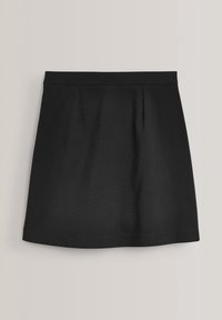 Jupe noire trapèze avec une taille cintrée et des plis subtils, présentée sur un fond neutre clair.