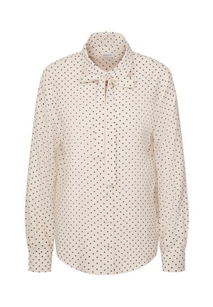 Kremowa bluzka z długim rękawem w czarne kropki, z zapinaniem na guziki z przodu, mankietami i kokardą przy kołnierzyku.