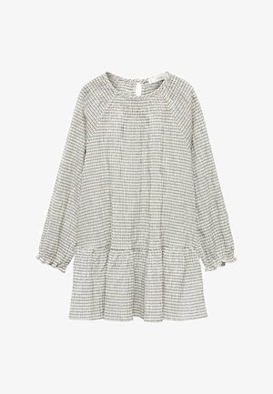 Robe à manches longues à carreaux blancs et noirs avec un col froncé, un ourlet en peplum et des manches à poignet. Fabriquée en tissu léger.