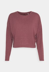 Maglietta corta a maniche lunghe color bordeaux realizzata in tessuto morbido con scollo rotondo e sottile dettaglio ritagliato sulla schiena. Vestibilità rilassata e finitura testurizzata.