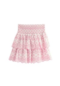 Gonna a strati rosa con vita arricciata, caratterizzata da un motivo floreale bianco e bordi a scallop. Realizzata in tessuto leggero.