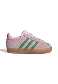 Pink suede sneaker with three green stripes, padded collar, light pink accents, and a gum rubber outsole featuring a textured pattern.