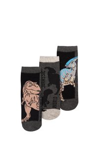 Tre paia di calzini con design di dinosauri. I colori includono nero, grigio e beige; le texture sono in maglia liscia con stampe grafiche.