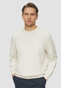 Lichtbeige crewneck sweatshirt, van een katoenmix, geribbelde boorden en onderkant, minimale branding op de borst, relaxed fit, zachte textuur.
