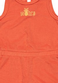 Pomarańczowy top na ramiączkach Roxy z żółtym haftem ananasa i okrągłym dekoltem. Miękki, lekki materiał z elastycznym pasem.