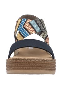 Black adjustable strap sandals with a woven geometric patterned upper, beige cushioned footbed, and braided jute platform outsole.