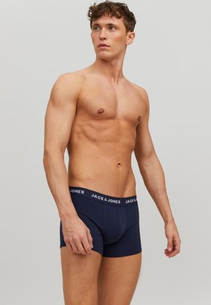 Marineblauwe heren boxershorts met een zachte elastische tailleband met daarop witte logo-tekst. Katoenen materiaal, aansluitend ontwerp en een gladde textuur.