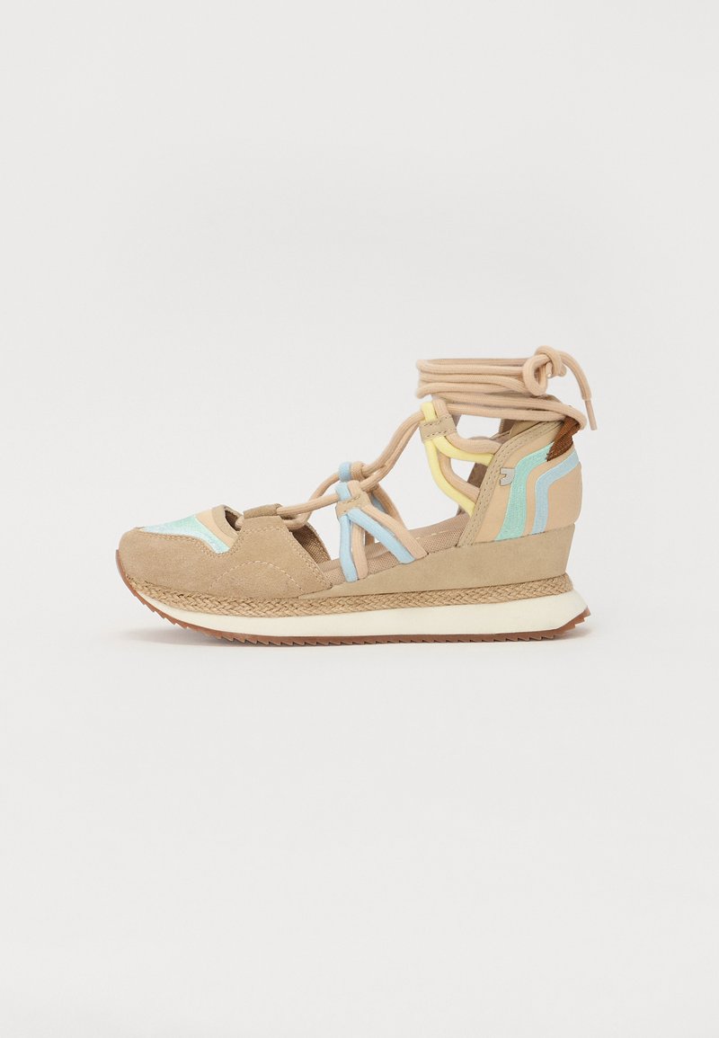 Sandalo in suede beige con accenti blu chiaro, giallo e marrone. Presenta un tacco a cuneo, design con lacci e una texture intrecciata attorno alla suola.