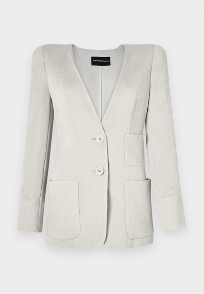 Light grey corduroy blazer with a deep V-neck, two front pockets, and two buttons. Features a textured finish and structured shoulders.