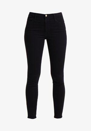 Mustat korkean vyötärön skinny-farkut, jotka on valmistettu denimestä, jossa on edessä nappisuljenta, viisi taskua ja minimaalista ommeltua.