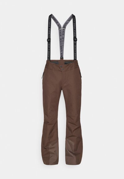 Brown ski pants with adjustable black-and-gray suspenders, zipper pockets, and reinforced lower sections for durability and protection.