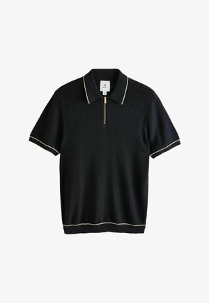 Polo shirt nero con maniche corte, tessuto texture, colletto con zip dorata e rifiniture color crema su maniche e orlo.