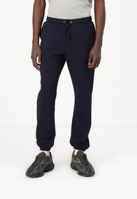Marineblauwe sweatpants van een katoenmix, met een elastische tailleband met trekkoord en ribgebreide boorden bij de enkels.