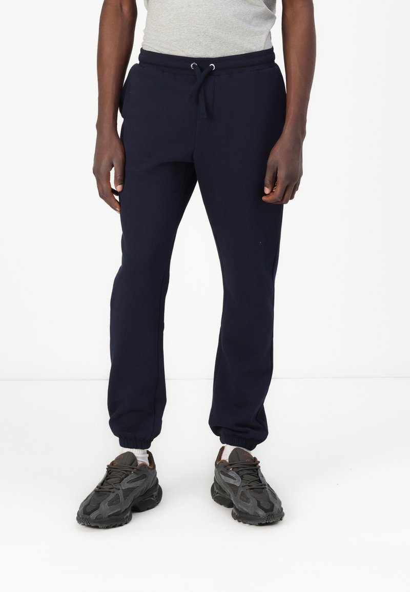 Marineblauwe sweatpants van een katoenmix, met een elastische tailleband met trekkoord en ribgebreide boorden bij de enkels.