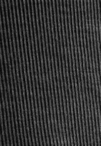 Black ribbed fabric with a textured appearance, featuring narrow vertical lines and slight sheen. The material is likely textile-based.