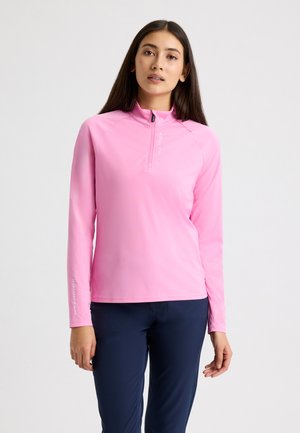 Camisa de manga larga con cierre en el cuello en un vibrante color rosa, con una textura suave y mangas raglán. Logotipo impreso en la manga izquierda.