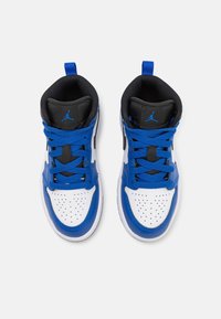 Mid-top sneakers in white, blue, and black. Features perforated toe box, laces in bright blue, and logo on the tongue and sides.