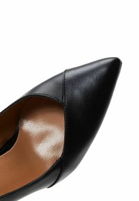 Black leather pump with a pointed toe, featuring a cutout design on the side and a smooth, textured inner lining.