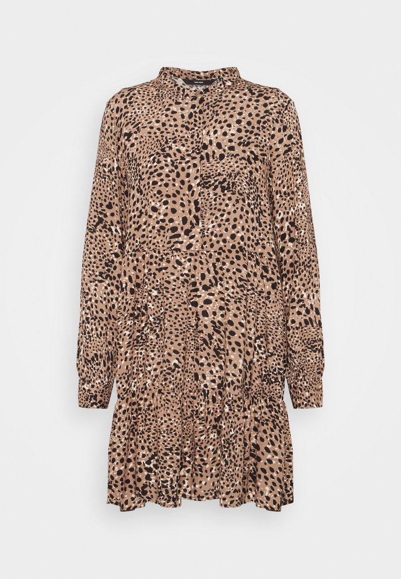 Dlouhý rukáv, béžové a černé puntíkované šaty s vysokým límcem a detailním sukňovým vrstvami.